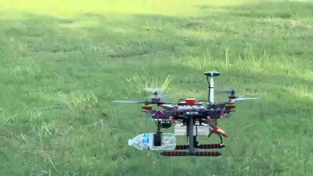 KaiLAB UAV on the grass with a payload attached during a field test